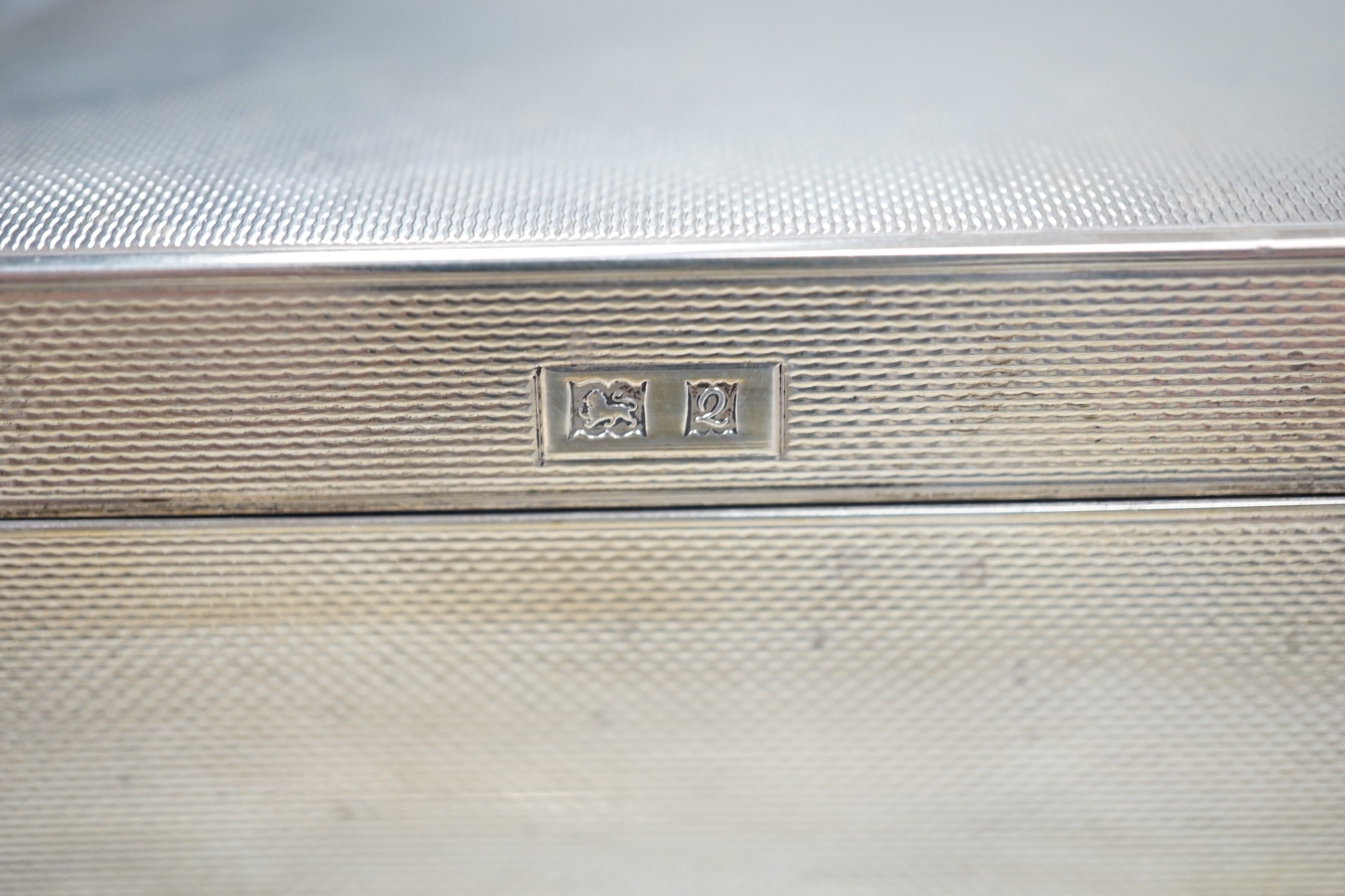 Two 1930's/1940's engine turned silver cigarette cases, largest 14cm and a later silver mounted cigarette box.